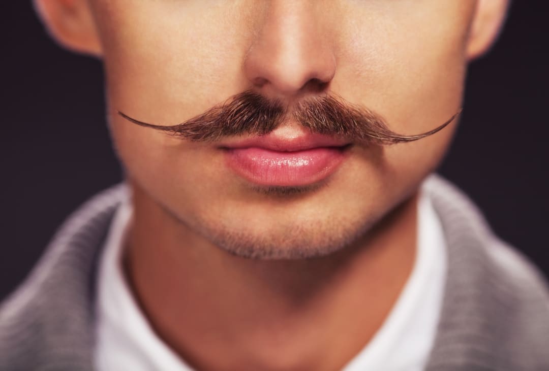 A man sporting a mustache who learned how to grow a mustache faster