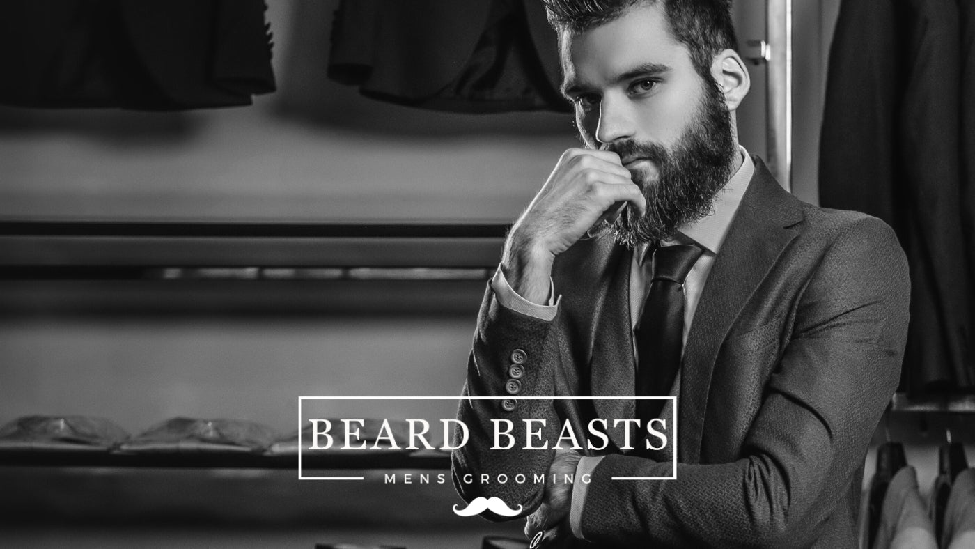 Elegant bearded man in a tailored suit pondering - Men's Fashion Tips For Beginners