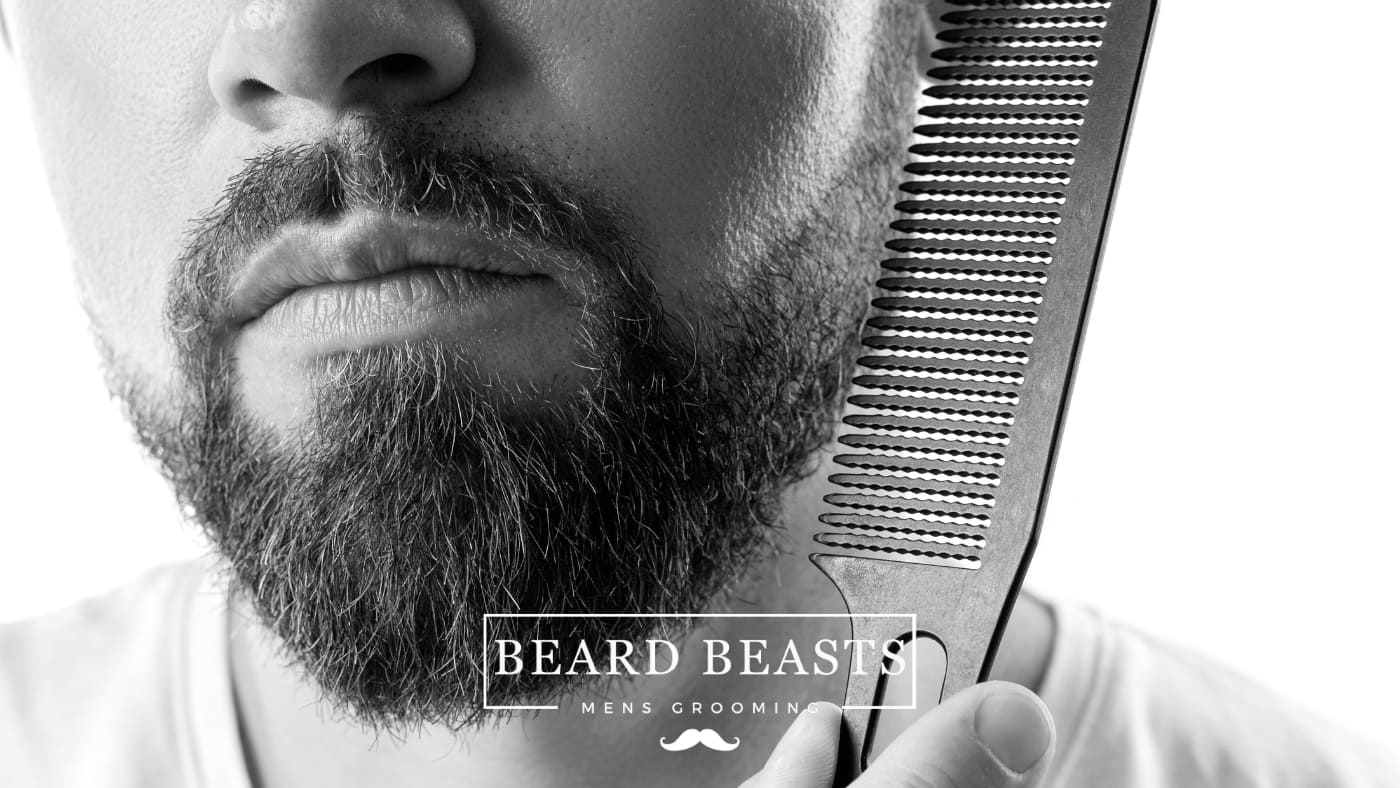 Man holding a comb next to a patchy beard highlighting common beard grooming mistakes by Beard Beasts Men's Grooming brand