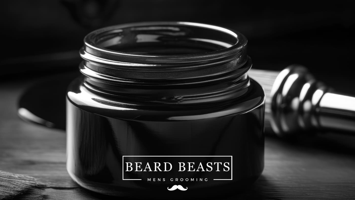 An elegant black jar of Beard Beasts men's grooming beard balm on a wooden surface, with a shaving brush beside it, suggesting a premium experience in how to use beard balm for beard care.