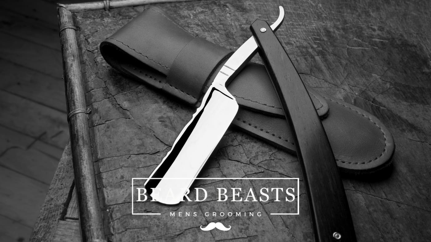 A monochrome image featuring a straight razor with a sleek, modern design, placed next to its leather case, symbolizing Beard Beasts Men's Grooming's commitment to classic shaving elegance.