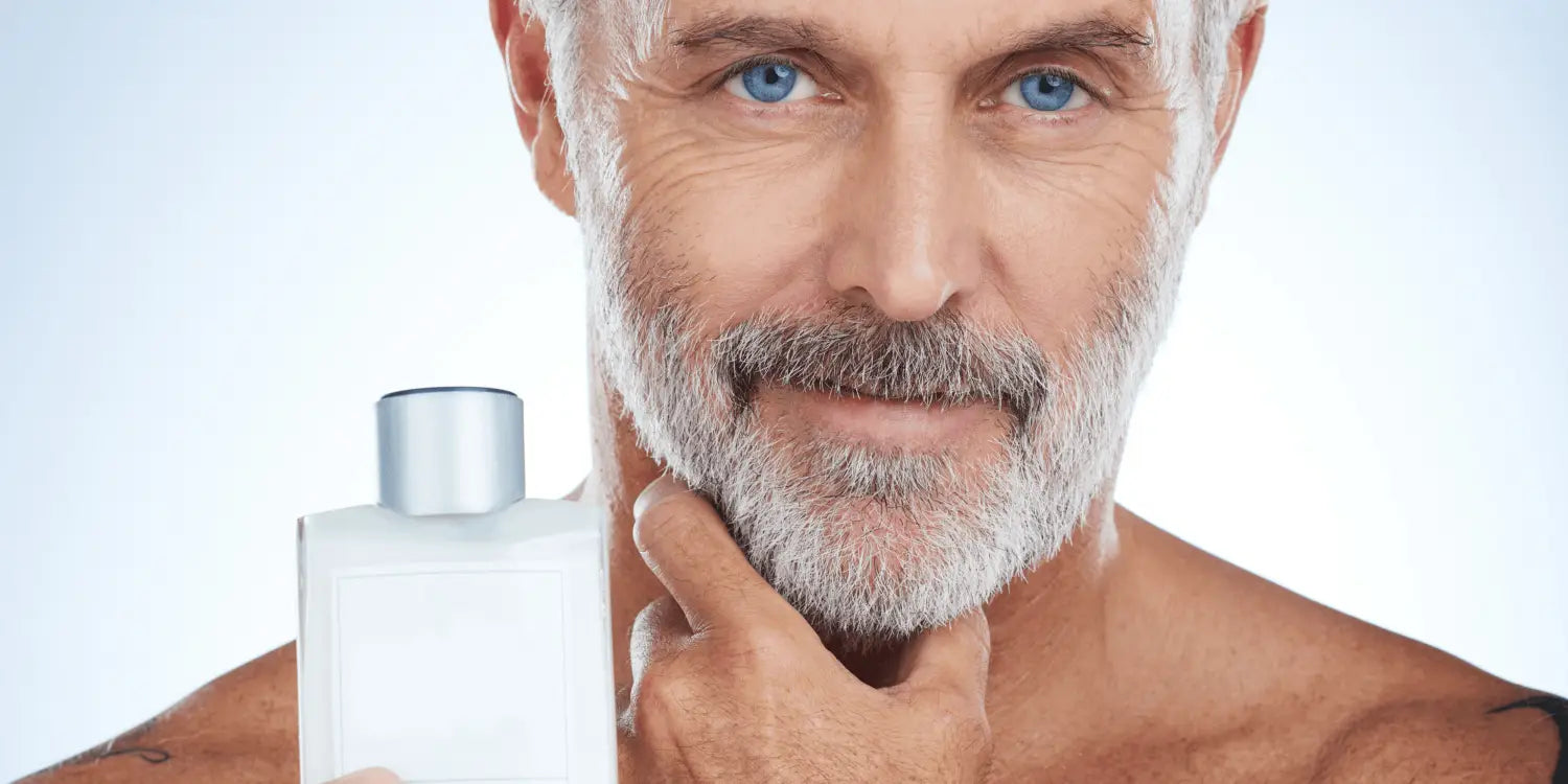 Bearded man confidently holding a bottle of premium beard conditioner, ready to combat the itchy beard phase with a smile.