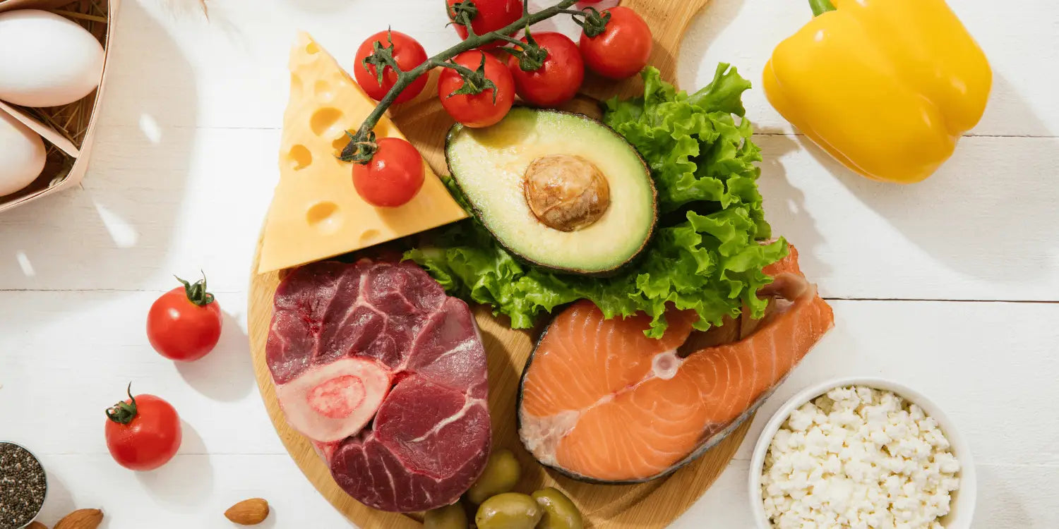 "Image of a rustic wooden chopping board generously laden with an array of healthy foods, including a perfectly grilled steak, a piece of freshly cooked fish, and a vibrant selection of vegetables such as crisp bell peppers, juicy tomatoes, leafy greens, and colorful root vegetables.