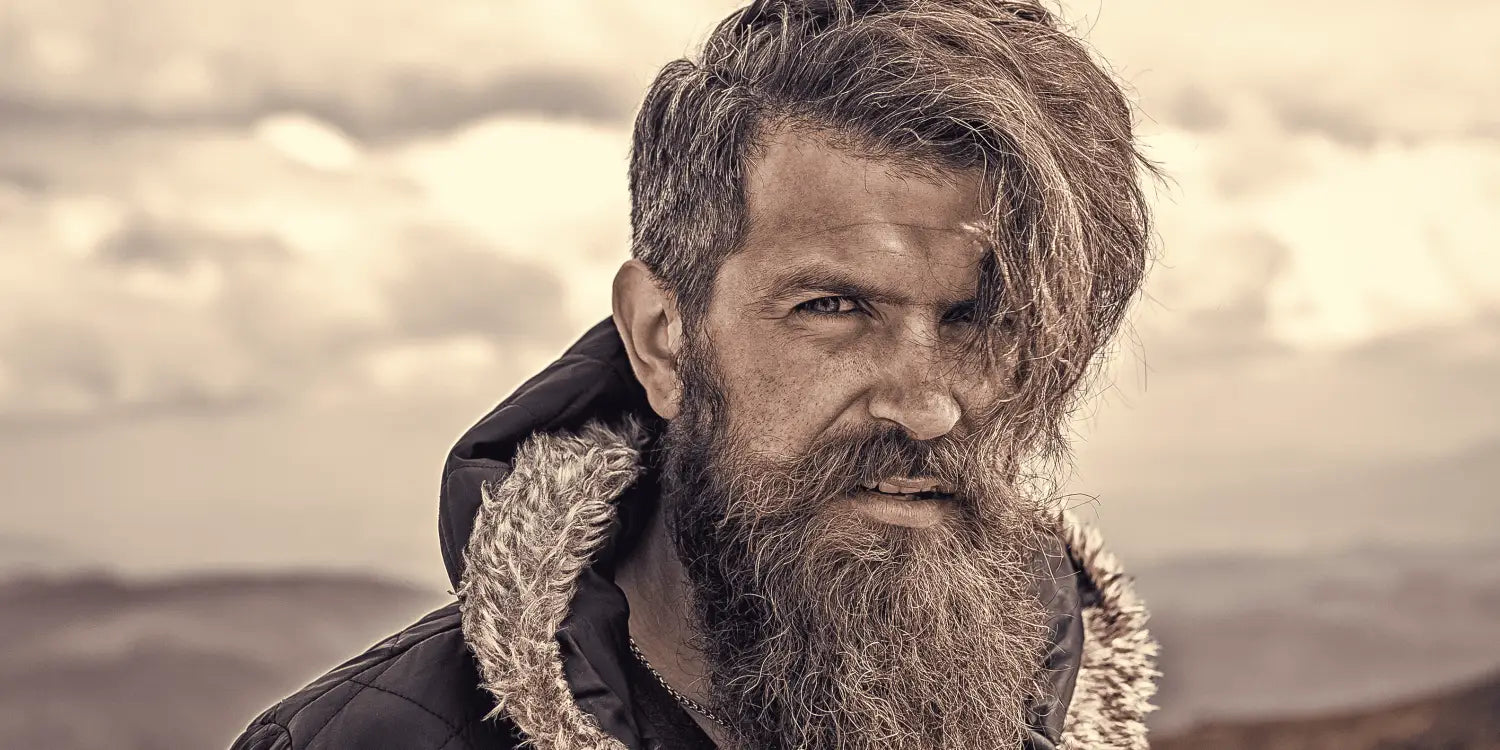 a bearded man looking towards the camera