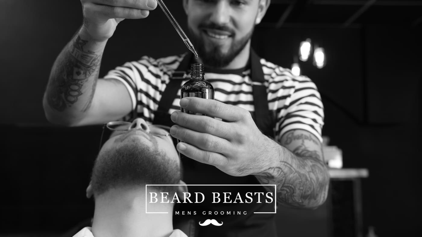 Professional barber applying beard oil, showcasing beard oil benefits for grooming, with Beard Beasts branding