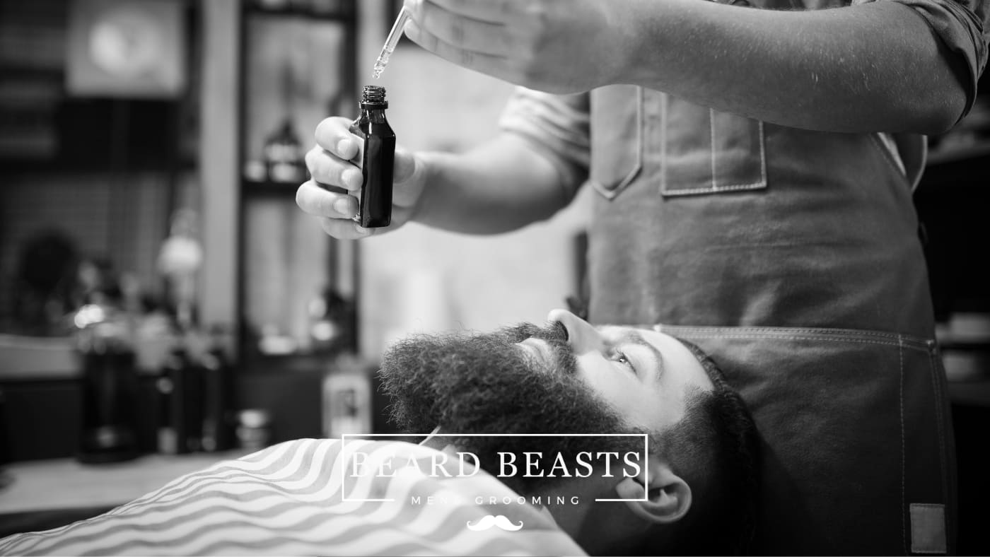 Barber applying premium beard oil with natural beard oil ingredients for grooming and maintenance at Beard Beasts Mens Grooming.