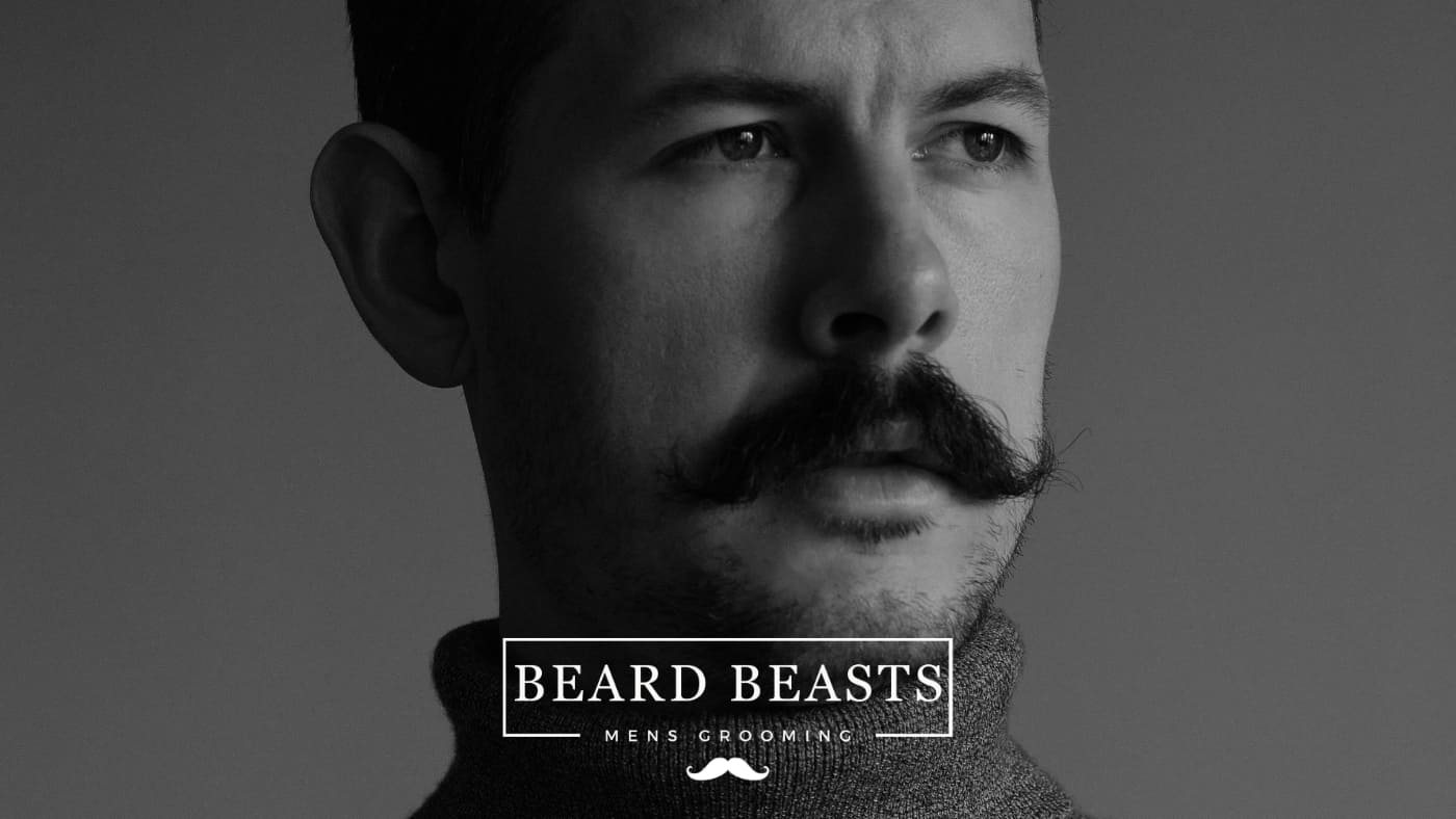 Profile view of a man with a styled mustache, epitomizing Beard Beasts men's grooming, with potential insights on preventing ingrown mustache hair.