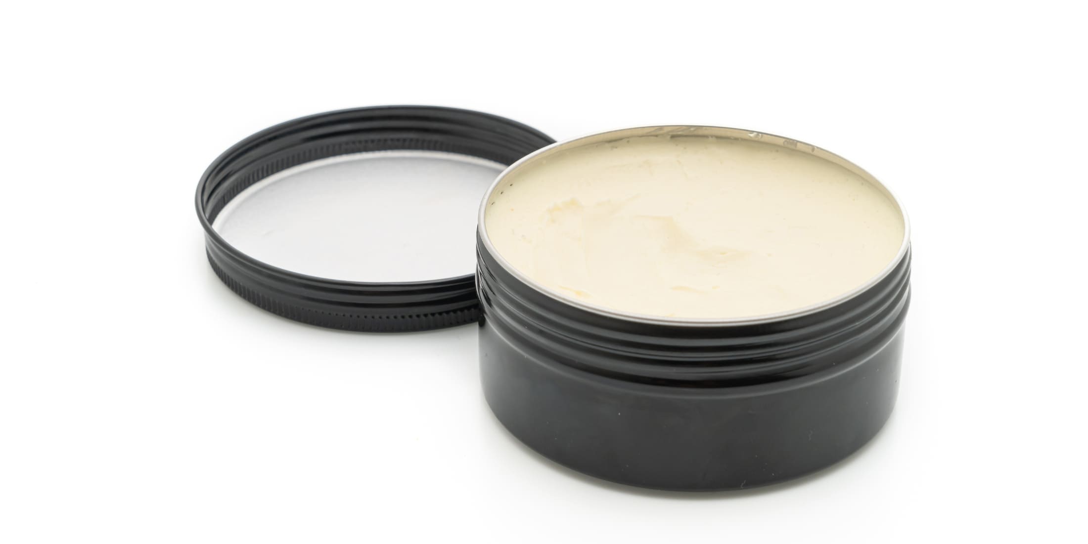Tin of hair pomade for men - ideal for achieving sleek, polished hairstyles with a shiny finish. Explore the benefits of hair pomade in the Clay vs Pomade guide