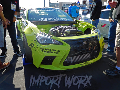 A modified 2015 Subaru BRZ in Lamborghini Verde Scandal color with Aimgain and Rocket Bunny body kit, featuring LS3 engine swap and Vortech blower at SEMA 2015.