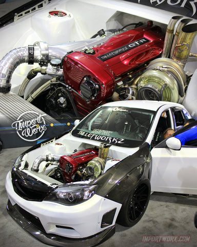 A white Subaru WRX with a Nissan Skyline GT-R engine swap, dubbed the "Panda WRX," showcased at the SEMA 2017 show. The car features a black and white exterior with carbon fiber accents, and a front-mid-mounted RB26DETT engine.