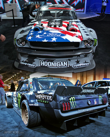 Ken Block's 1965 Ford Mustang with custom widebody kit, twin-turbocharged Roush Yates V8 engine, and unique livery, performing a drift.