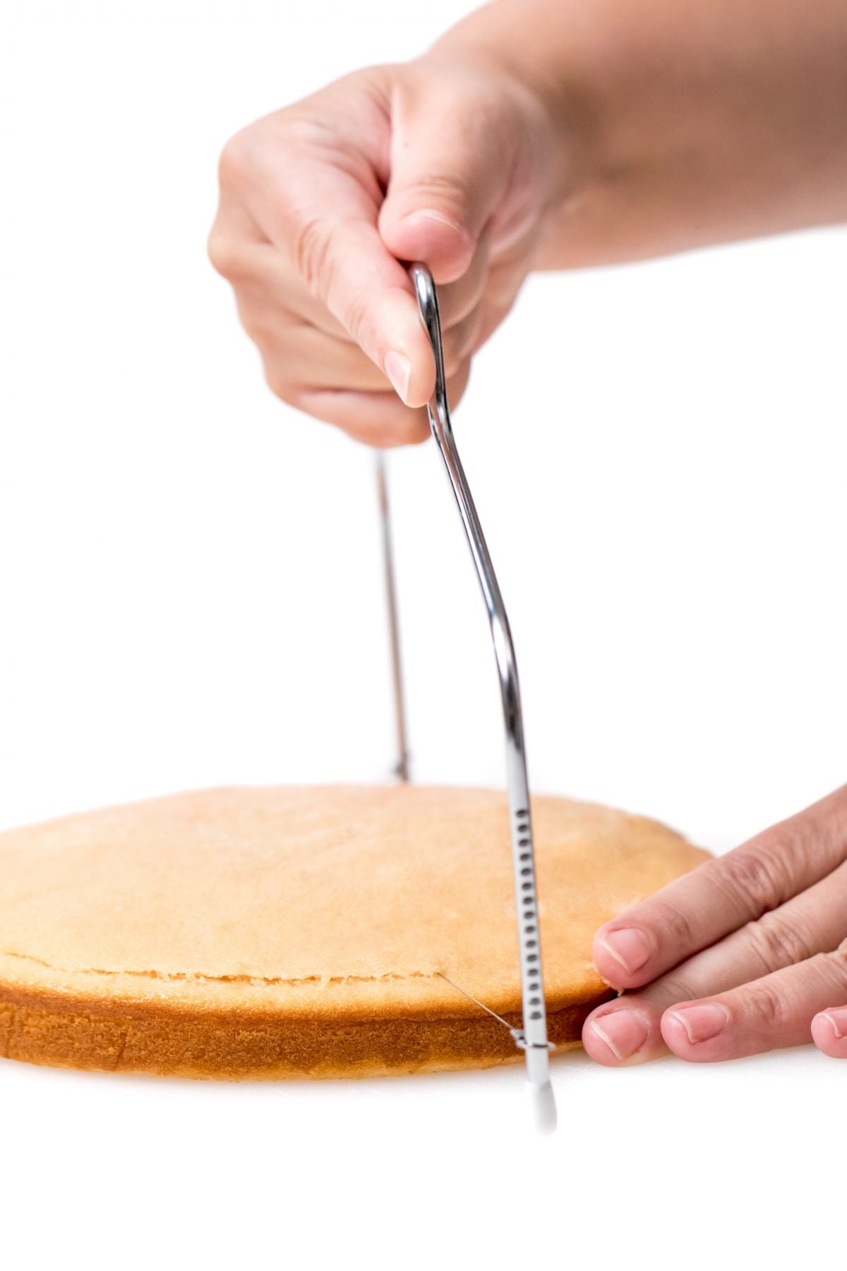 SLICE A THIN LAYER FROM THE TOP OF EACH CAKE TO CREATE A FLAT SURFACE