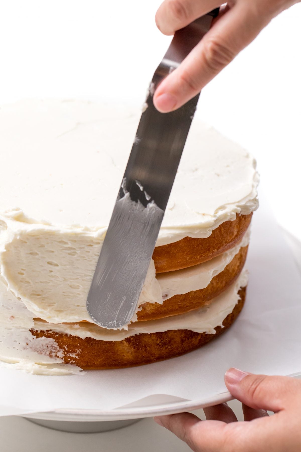 APPLY BUTTER CREAM ICING TO SIDES OF CAKE