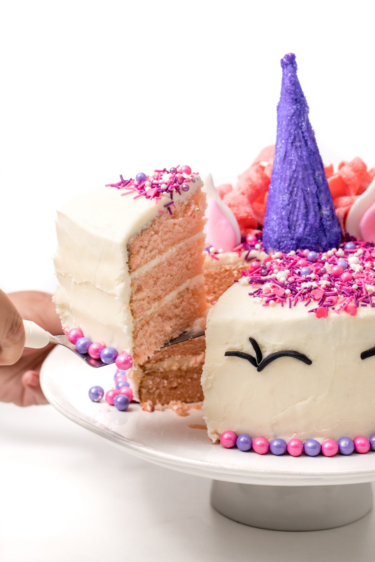 cut out a slice of unicorn cake