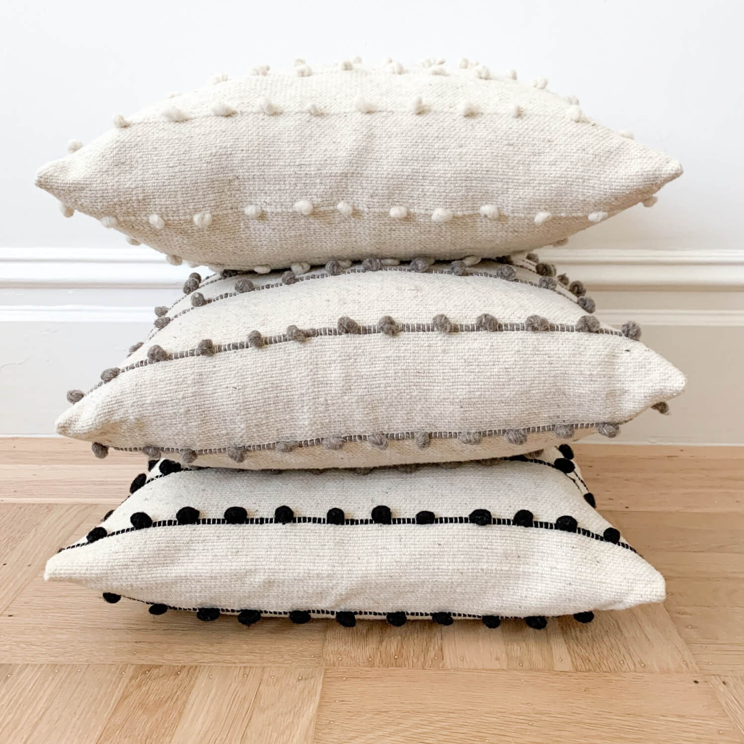 https://cdn.shopify.com/s/files/1/0255/3197/3666/products/Stacked-Wool-Throw-Pillows-Mexico_f27ad3db-8eeb-41fe-8a59-5e1858253a4c_2048x2048.jpg?v=1674543975