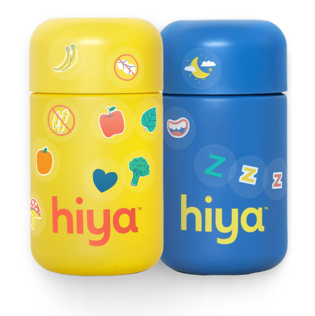 A blue Hiya's Kids Bedtime Essentials bottle on the left with a yellow Hiya's Kids Daily Multivitamin bottle on the right both decorated with stickers.