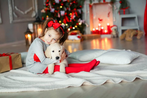 Young girl with her puppy Christmas gift.