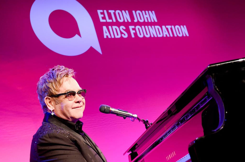 Elton John singing and playing piano