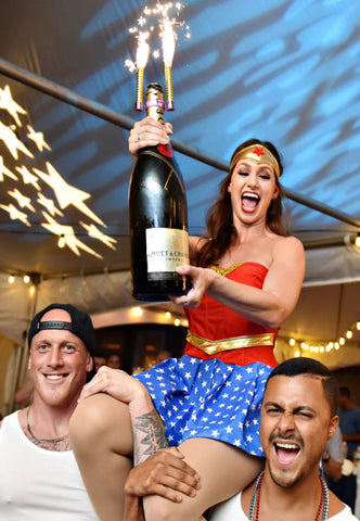Waitress celebrating with bottle top sparklers 