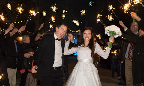 Bride and Groom walking through a glimmer of sparklers