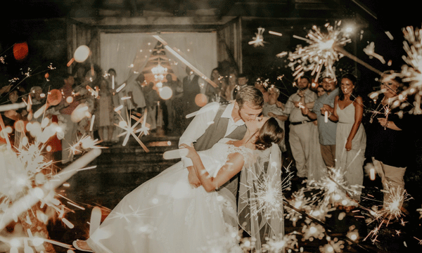 Bride and groom captivated in their kiss and 36 inch wedding sparklers exit