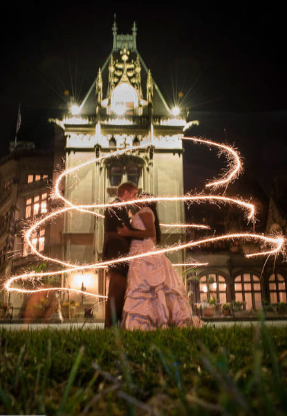 Bride and Groom consumed with beautiful gold sparklers from 20 inch wedding sparklers