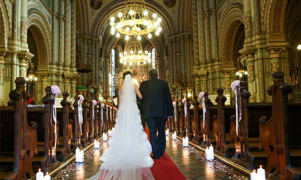 Bride walking in church at wedding ceremony