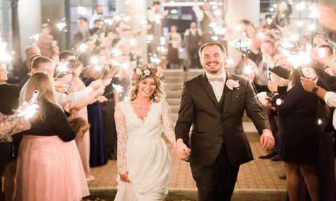 wedding sparklers glowing down the aisle for newlyweds