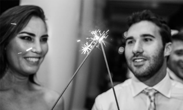 Bride and groom lighting wedding sparklers together