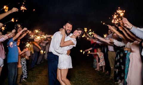 Couple enjoying their wedding exit with wedding sparklers