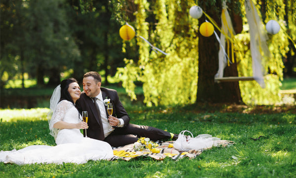 Bride and groom having an outdoor picnic together