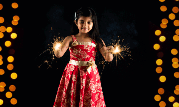 Flower girl using wedding sparklers 