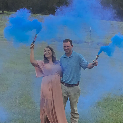 blue smoke bomb gender reveal in open environment