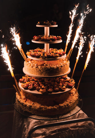 Cake sparklers shimmering on wedding cake