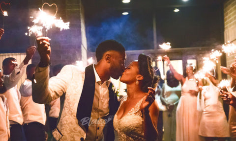 Newlyweds letting their love sparkle with wedding heart sparklers