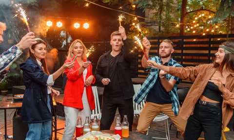 friends celebrating new years with bottle top sparklers