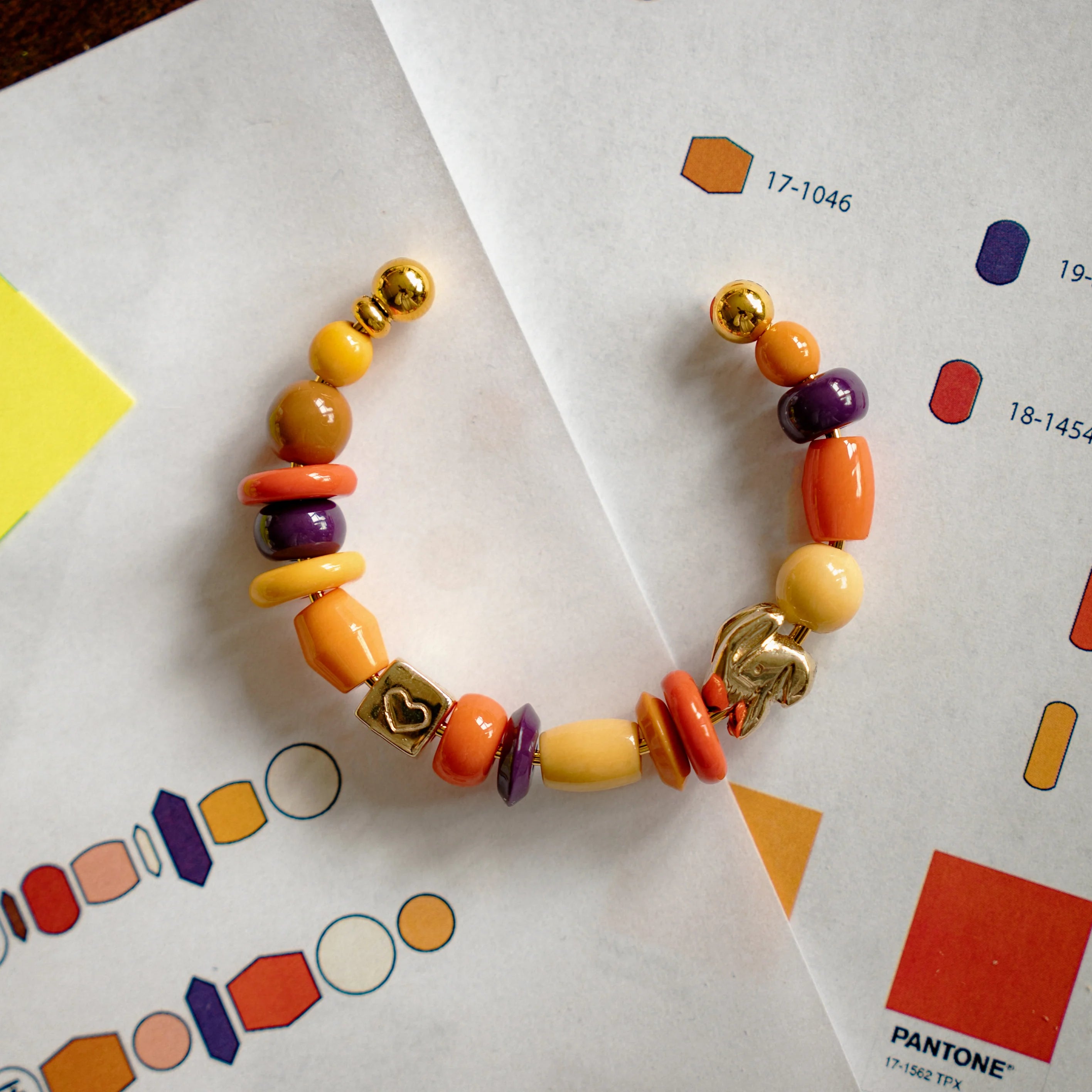 Memory Palace Bracelet resting on paper with color swatches