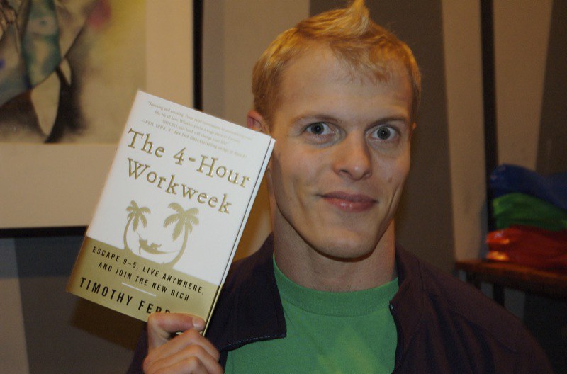 Tim Ferriss with his book, The 4-Hour Workweek that released in 2007.