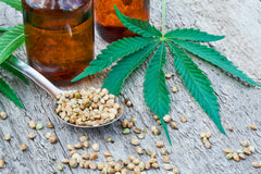 hemp seeds, cbd oil, and hemp leaf