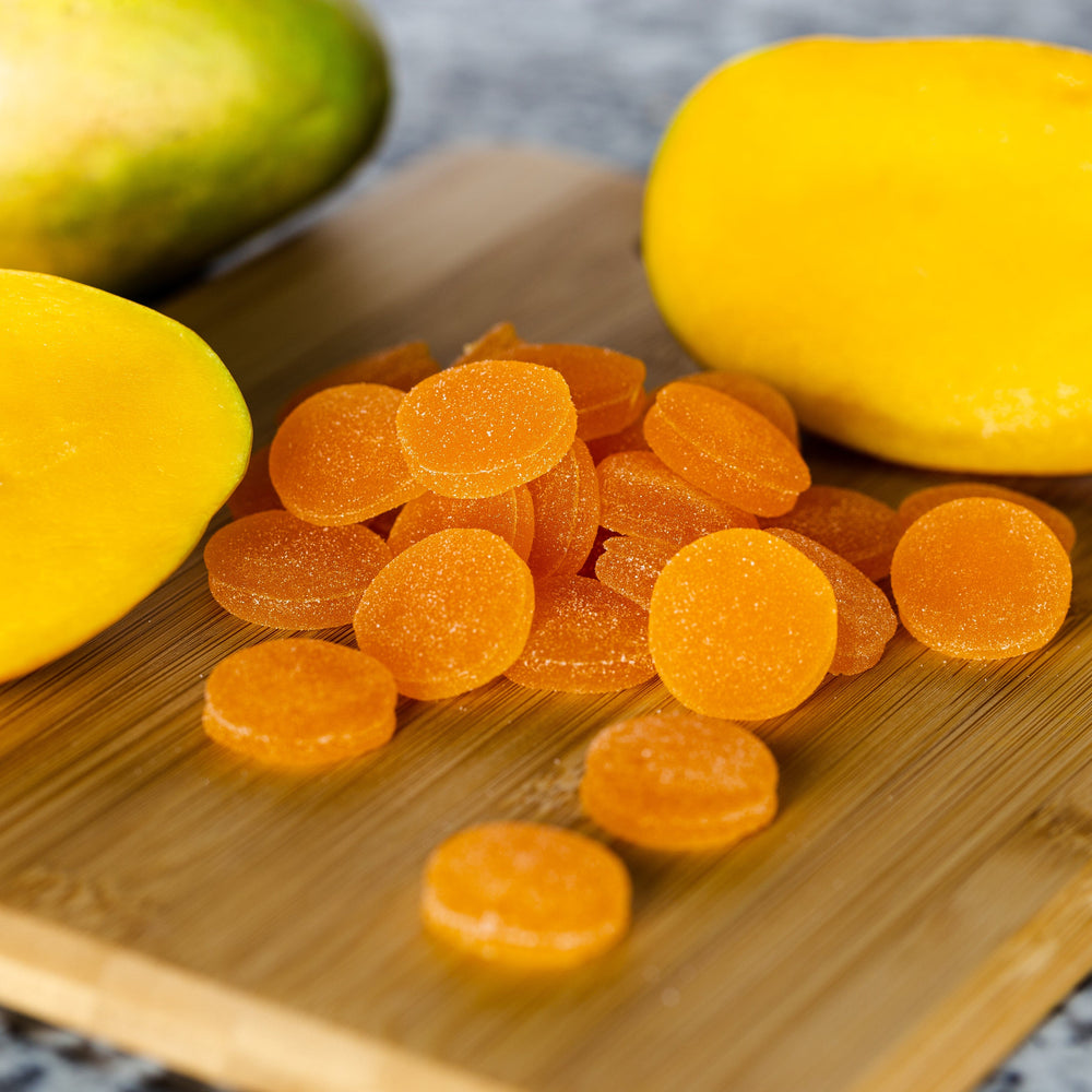 Select Spectrum Gummies (Mango) on a cutting board