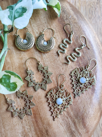 collection of brass jewellery on wooden surface