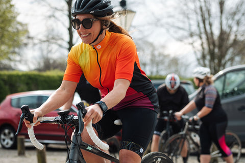 fat lass at the back women cycling orange yellow jersey cycle wear plus size on bike