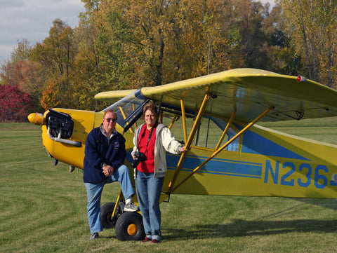 A photo of John M. White and Betty Alicia White in front of her Piper J-3 Cub.
