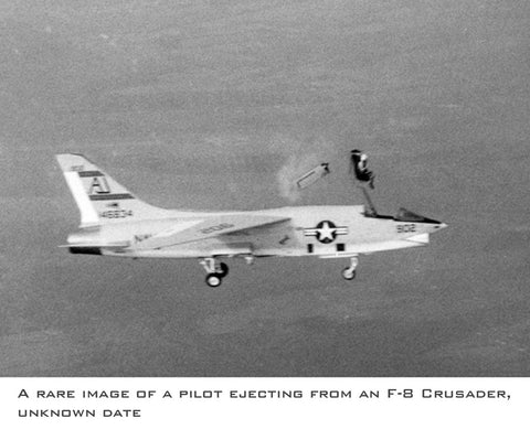 F-8 Crusader falling towards the ocean while the pilot ejects from the aircraft.