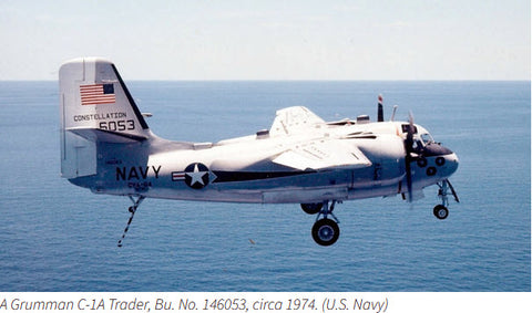 A Navy Grumman C-1A with tailhook extended heading for a landing on a carrier.