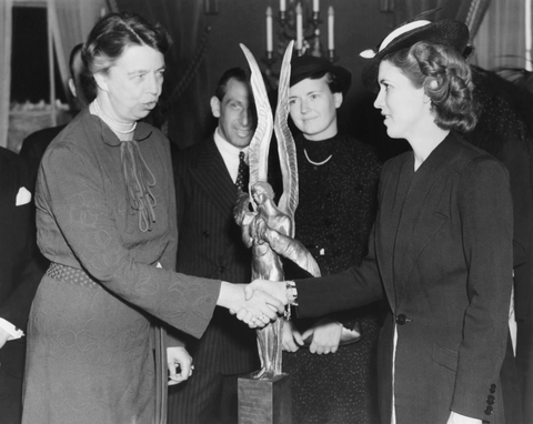 Jackie Cochran is presented the Harmon International Aviatrix Trophy by Mrs. Franklin D. Roosevelt.