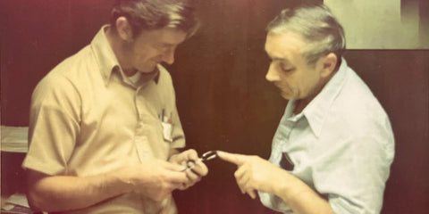 Stan and Jan examining an optical frame hammering out the technical details of how to manufacture quality products which were the forebearers of the Randolph frames which last so long.