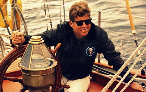 JFK sailing wearing AO Eyewear Saratoga sunglasses with a Tortoise Frame and True Color Calobar Green lenses.