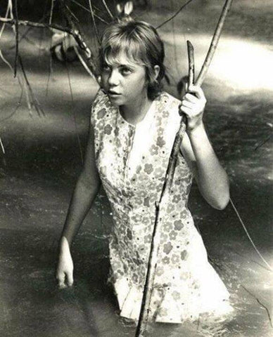 Juliane Koepcke is photgraphed as she arrives at Pucallpa wading in a stream.