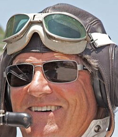 A pleasure pilot enjoying an open cockpit flight wearing a pair of Sheyden Fixed Gear Mustang Aviator Sunglasses